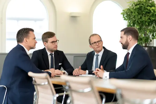 Vier Männer in einem Meetingraum